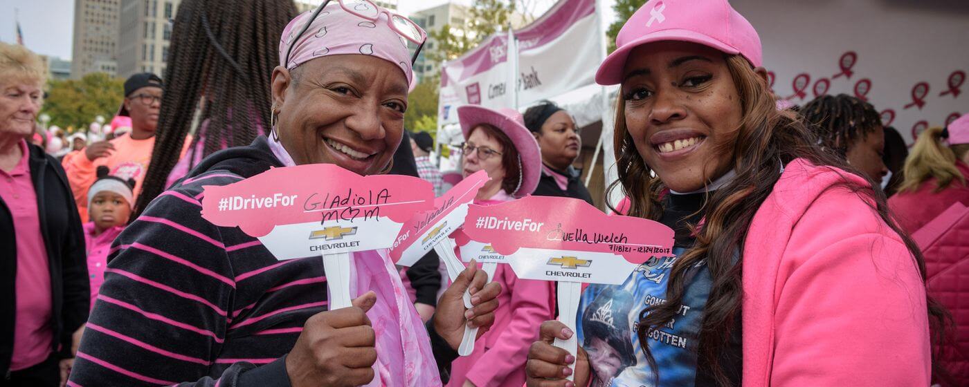 image of 2 women holding signs